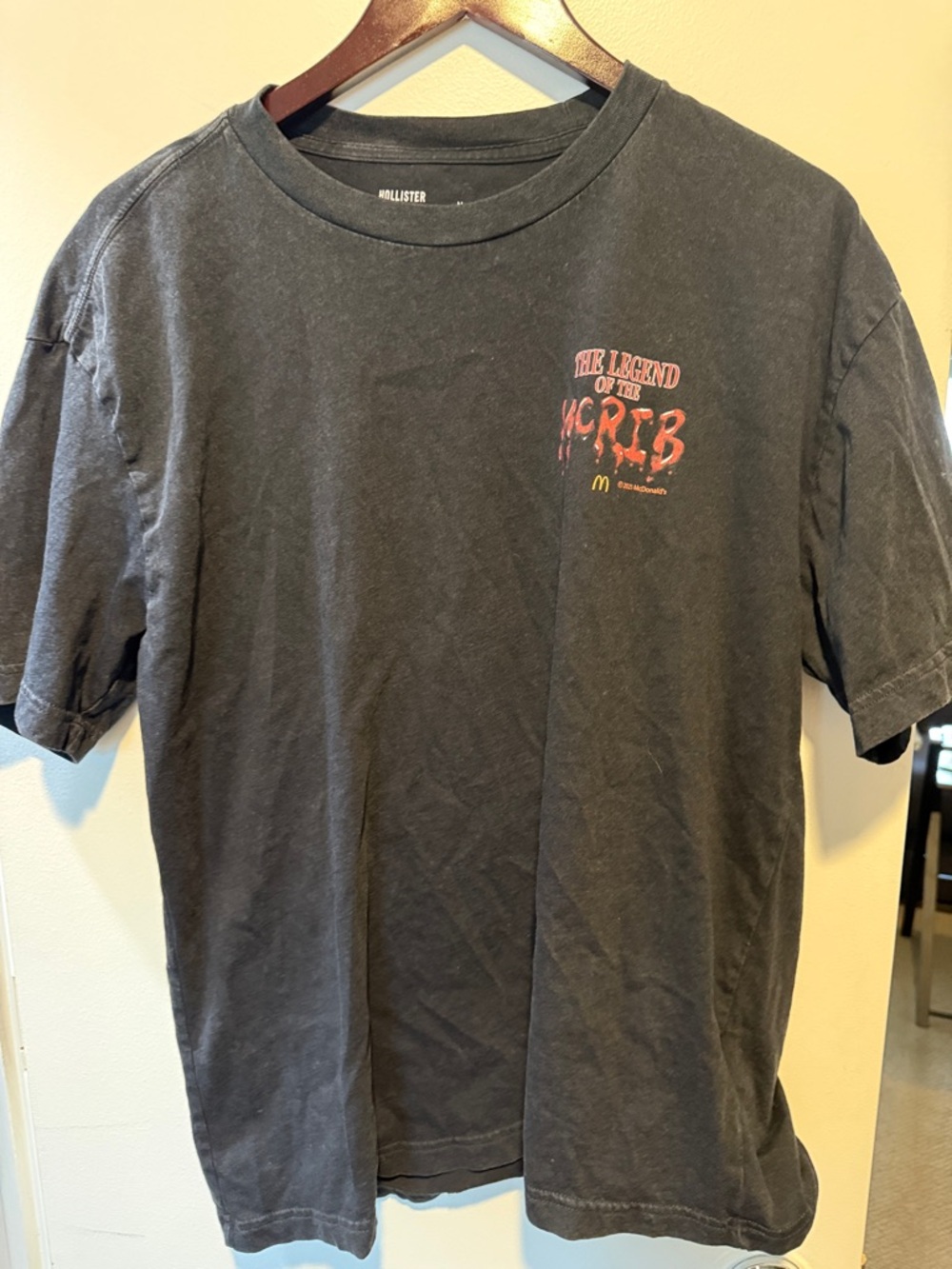 Hollister McRib Black Tee with Small Red Chest Graphic and Yellow Detail